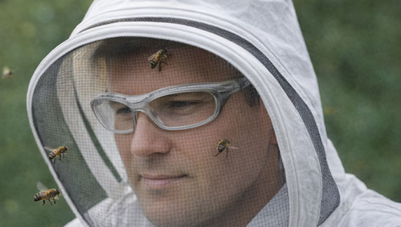 Bee keeper wearing protective glasses